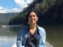 Laura Fernández Cascán sitting on a boat, floating on a river in Peru